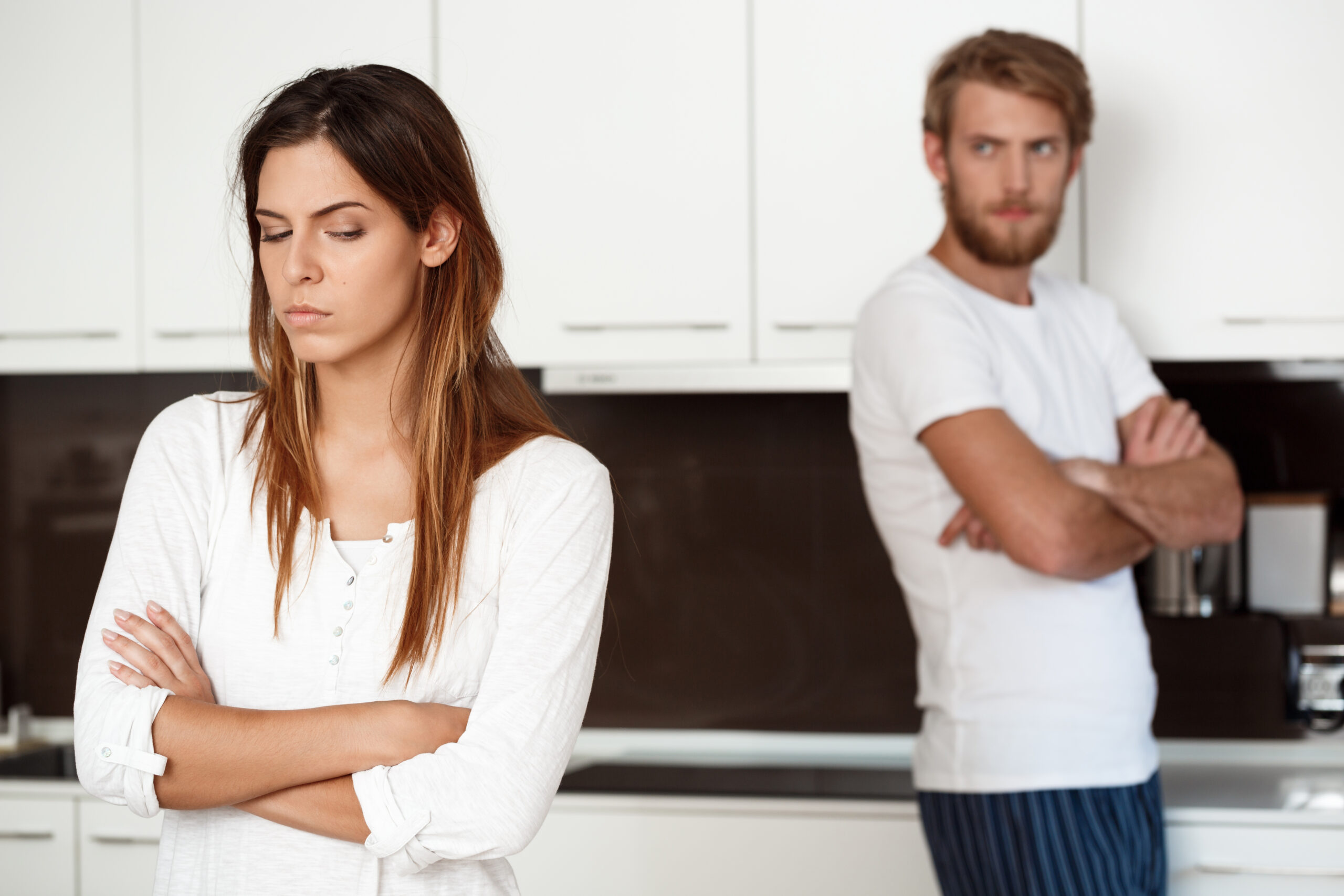 Displeased beautiful brunette girl in quarrel with her boyfriend background.